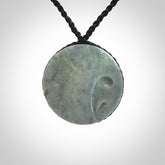 This piece is a contemporary disc pendant hand carved in New Zealand jade.