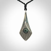 This is a hand carved Sterling Silver lantern drop pendant with New Zealand Jade insert. This is a medium sized necklace and is provided with an adjustable black cord.