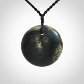 A Hand Carved New Zealand jade disc pendant