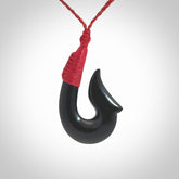 This piece is a hand carved black jade matau pendant, otherwise known as a traditional fish hook necklace.