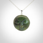 Hand made New Zealand Jade moon face necklace with Sterling Silver. Made by NZ Pacific and sale online only. Delivered with sterling silver chain and packaged in a woven kete pouch.