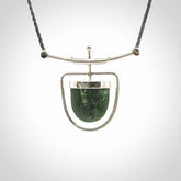 Hand crafted contemporary green jade and sterling silver drop necklace. This necklace is provided with a adjustable cord. Contemporary green jade drop necklace with sterling silver.