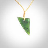 This is a lovely New Zealand Jade, pounamu niho drop pendant. Hand carved for us by Ric Moor. It is bound with an adjustable beige coloured cord which is length adjustable. Free worldwide shipping.