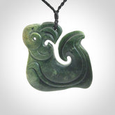 A beautiful hand carved, New Zealand Jade Matau, hook pendant.