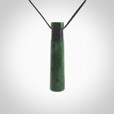 This photo shows a large jade drop shaped pendant. It a a lovely deep green Marsden jade. The cord is black and is adjustable in length. One only large, contemporary drop necklace from Jade, by Rueben Tipene.