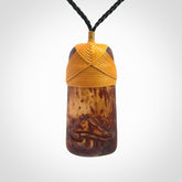 A hand carved bone toki pendant with NZ Pacific logo engraving. These have been stained with our home made tea dye. Unique hand made jewellery from New Zealand Pacific.
