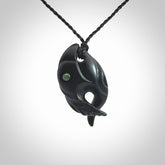 This is a hand carved Black Jade bird head pendant with New Zealand Jade insert. This is a smaller sized necklace and is provided with an adjustable black cord.