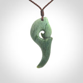 Hand carved huia bird skull made from New Zealand Marsden Jade pendant. Carved for NZ Pacific by Kyohei Noguchi. This is a contemporary piece of jewellery that is carved with intricate detail and clearly shows a beautiful bird skull.