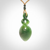 Hand carved New Zealand jade twist pendant. Carved in New Zealand by NZ Pacific. Unique double twist jewellery for sale online. Provided with an adjustable tan cord.