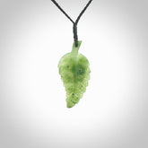 A delicate green jade fern leaf pendant with an adjustable neck cord. Green stone fern leaf necklace with adjustable cord. Delivery included.