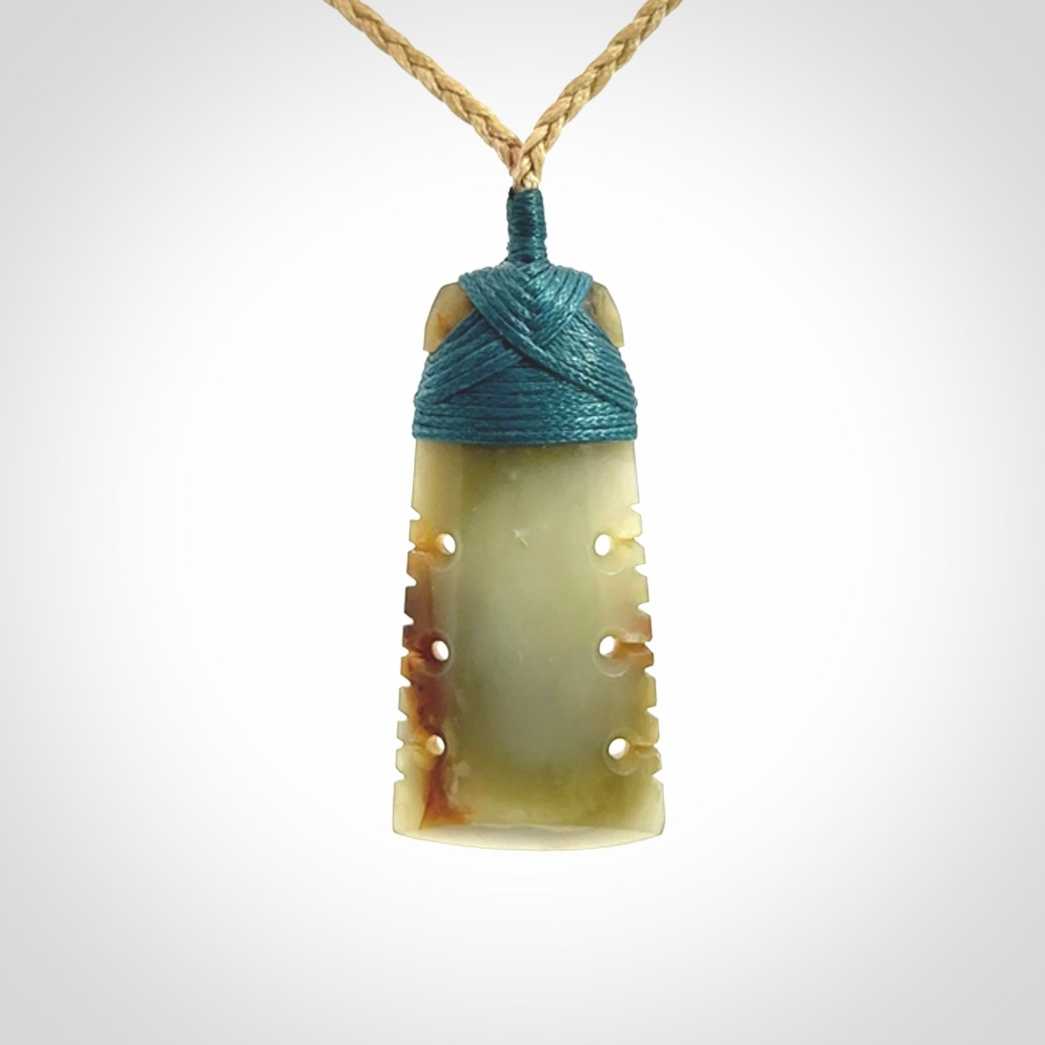 A beautiful, notched, New Zealand jade toki pendant
