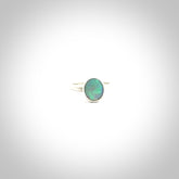 This is a handcrafted real opal ring with sterling silver. The colours are a gorgeous turquoise blue. This is a solid little work of art. We ship this worldwide for free and are happy to answer any questions that you may have about these or other products on our website.