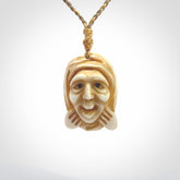 Hand carved incredible stained bone gargoyle face carving. A stunning work of art. This pendant was hand carved in bone with buffalo horn inlay for the eyes by Yuri Terenyi. A one off collectors item that has been hand crafted to be worn or displayed.
