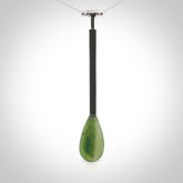 This pendant is a hand carved boat paddle. We have carved this with a Black jade blade or a green jade blade with a hardwood and sterling silver handle. Provided with a sterling silver chain.