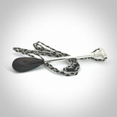 This pendant is a hand carved boat paddle. We have carved this with a Black jade blade or a green jade blade with sterling silver handle. Provided with an adjustable cord.