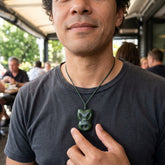 Man wearing jade wheku pendant