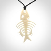 Hand carved bone fish skeleton pendant. Hand made bone fish necklace. Fish themed jewellery. Ocean themed pendant. One only necklace provided with adjustable cord and free delivery.