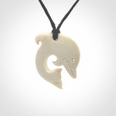 Hand carved bone dolphin pendant with black adjustable cord.