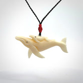 Hand carved bone whale and whale calf pendant