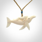 Hand carved bone whale and whale calf pendant