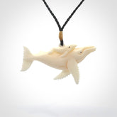 Hand carved bone whale and whale calf pendant