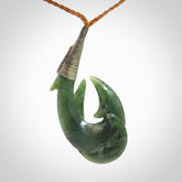 Hand carved double Jade matau hook pendant. The cord is length adjustable.