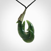 Hand carved double Jade matau hook pendant. The cord is length adjustable.