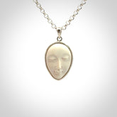 Hand made woolly mammoth tusk moon face necklace. Made by NZ Pacific and sale online only.