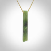 This photo shows a large Totoweka jade drop shaped pendant. It a a lovely, semi-translucent jade. The cord is tan and is adjustable in length. One only large, contemporary drop necklace from New Zealand Totoweka Jade, by Rueben Tipene.