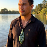 A man wearing a large New Zealand Jade pendant