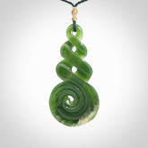 Ross Crump triple twist with koru pendant. Hand carved from rare New Zealand jade this is a beautiful pounamu pendant. The cord is length adjustable. It is a delicate and very beautiful greenstone pendant. For sale online by NZ Pacific.
