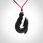 These pendants are hand carved, black jade hooks or matau pendants. They are beautifully finished in a polish and bound with adjustable necklace cords