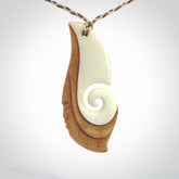 A hand carved bone contemporary, intricate pendant. The cord is a 4 strand, 3 plait in Ice White and Tan and is an adjustable length. A large sized hand made contemporary necklace by New Zealand artist Kerry Thompson. Kerry has stained parts of the bone which really add to the dimension of this pendant. One of work of art to wear.