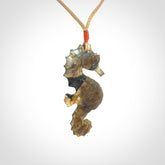 A hand carved labradorite seahorse pendant. We have carved this from beautiful labradorite and we bind them with our hand-plaited cords. The cords are a waxed polyester so they are durable and strong. We ship these worldwide with express courier anywhere in the world.