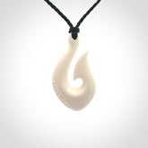 Hand carved bone hook pendants