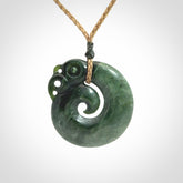 New Zealand Jade Koru Manaia. Hand carved Koropepe pendant. Made in New Zealand. Real Jade, pounamu. Real New Zealand Jade Manaia with Koru necklace with a polished finish.