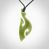 This photo shows a hook with koru pendant carved from New Zealand Jade. We provide this piece with an adjustable Manuka Green cord.