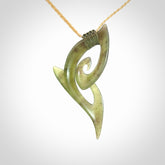 This photo shows a koru pendant carved from New Zealand Jade. We provide this piece with an adjustable oat coloured cord.