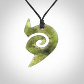 This photo shows a koru pendant carved from New Zealand Jade. The artist, Shaun Gardiner, has carved this beautifully. We provide this piece with an adjustable black cord. This is a fantastic work of art, we have one only.