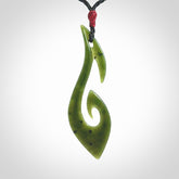 This photo shows a large hook with koru pendant carved from New Zealand Jade. We provide this piece with an adjustable black cord.