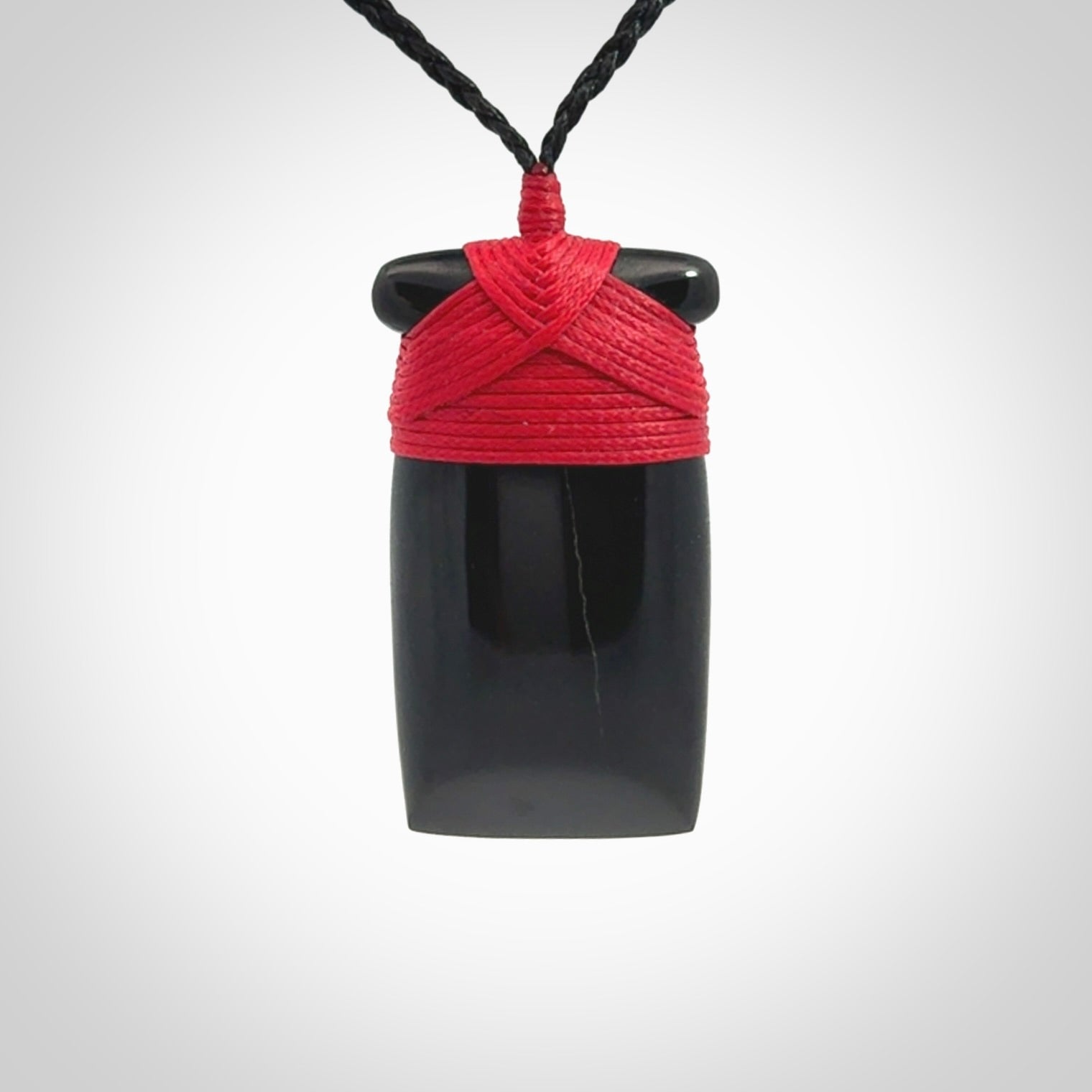 Hand carved black jade toki pendant. Made by NZ Pacific from Australian black jade. Black Jade Toki provided with adjustable cords and packaged in a woven kete pouch. Delivered with express courier.