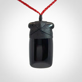 Hand carved black jade toki pendant. Made by NZ Pacific from Australian black jade. Black Jade Toki provided with adjustable cords and packaged in a woven kete pouch. Delivered with express courier.
