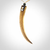 This is a hand carved rams horn huia bird beak pendant. It is made from rams horn with 24 carat gold leaf and jade toggle. This is a large sized necklace and is a very unique, one only, pendant that is a collectors piece. Hand carved by New Zealand artist, Sami.
