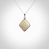 Hand carved mammoth tusk pendant. Hand made by NZ Pacific for sale online. Delivered with a sterling silver chain and packaged in a woven kete pouch.