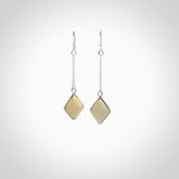 Hand carved mammoth tusk earrings. Hand made by NZ Pacific for sale online. Ancient Woolly Mammoth Tusk earrings, packaged in a woven kete pouch.