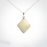 Hand carved mammoth tusk pendant. Hand made by NZ Pacific for sale online. Delivered with a sterling silver chain and packaged in a woven kete pouch.