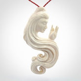 This is a contemporary large female pendant carved in bone. Hand carved and provided with an adjustable cord. Woman with shuni mudra hand gesture pendant.