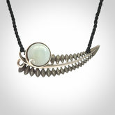 This is a hand carved Sterling Silver Fern leaf pendant with Siberian Jade insert. This is a medium sized necklace and is provided with an adjustable black cord.