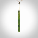 This picture shows a hand carved jade drop pendant by Ric Moor. The jade is a wonderful light, semi-translucent, green. It is suspended from a meringue coloured adjustable cord. Delivery is free worldwide.