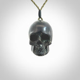 This picture shows a large sized Snowflake Obsidian stone skull pendant that we have hand carved. It is polished to a soft shine and is a very striking piece. Provided with an adjustable khaki cord.